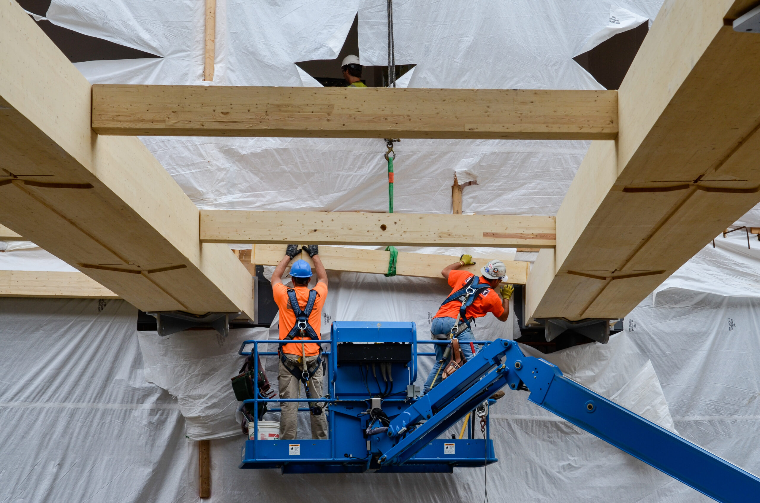 Installers setting mass timber beams, John W. Olver Design Building, UMass Amherst