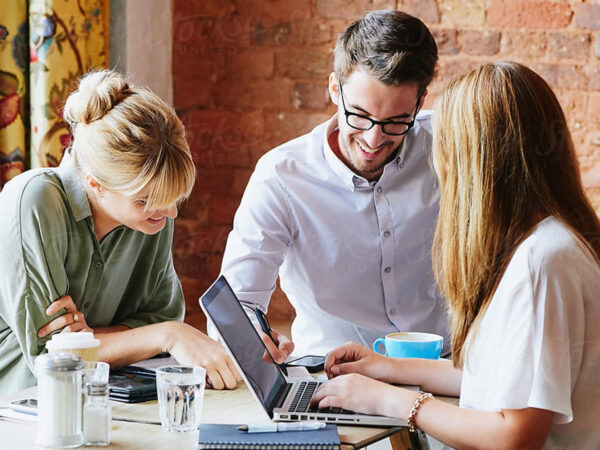 Two women and a man working on a project together