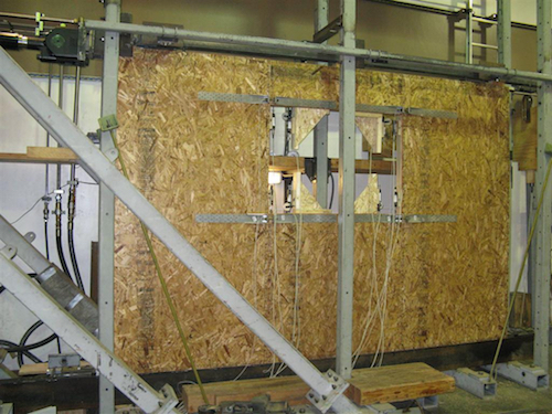 metal straps in a wood-frame shear wall with an opening in the center