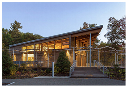 One story building at dusk with light shining through the windows