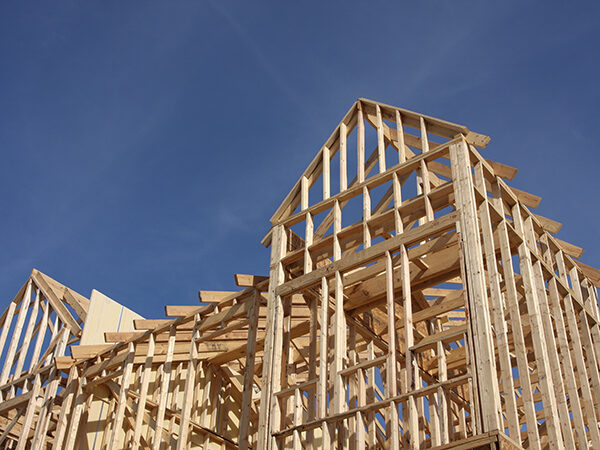 Building Frame Construction Against Blue Sky