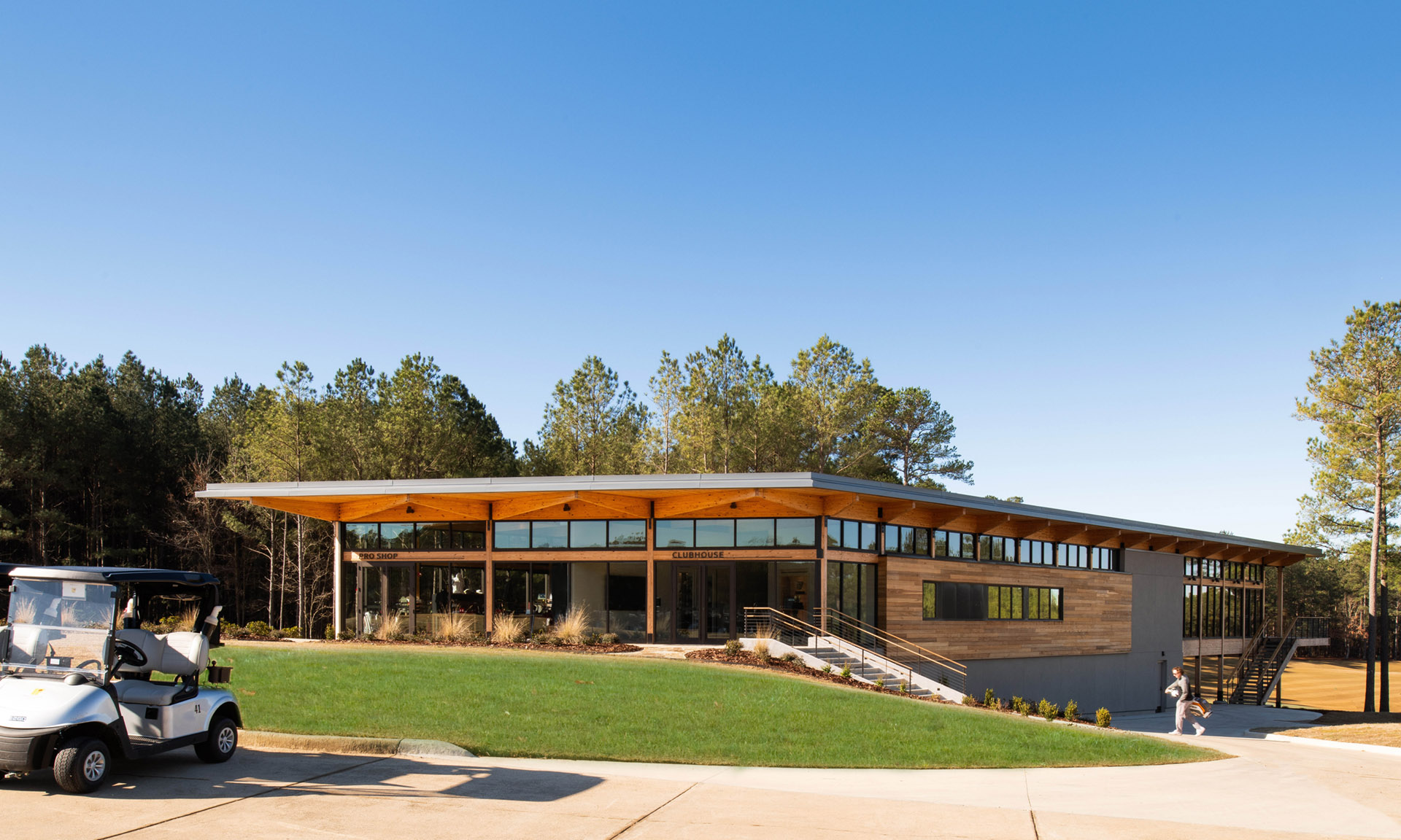 Mystic Creek Clubhouse exterior with golf cart