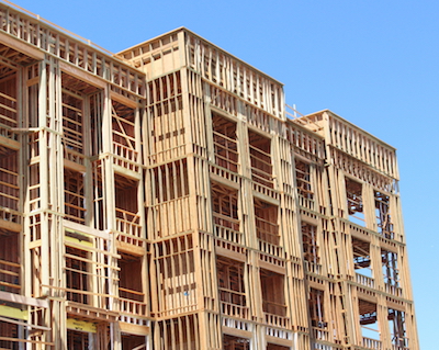 Unfinished wood-frame multi-family/mixed use building exterior