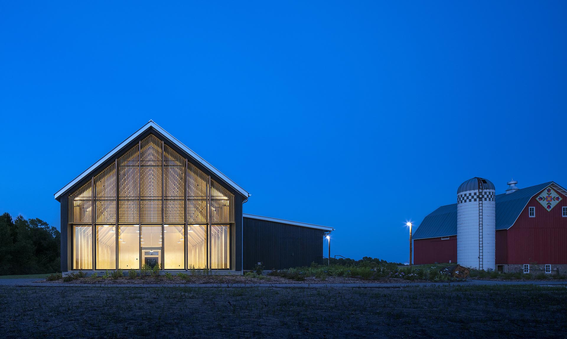 Tashjian Bee and Pollinator Discovery Center exterior lit up